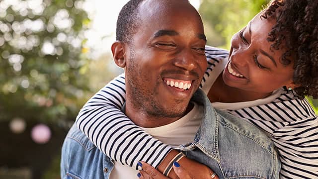A couple smiling outside