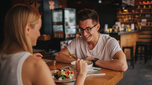 Happy young couple having nice date in bar of restuarant