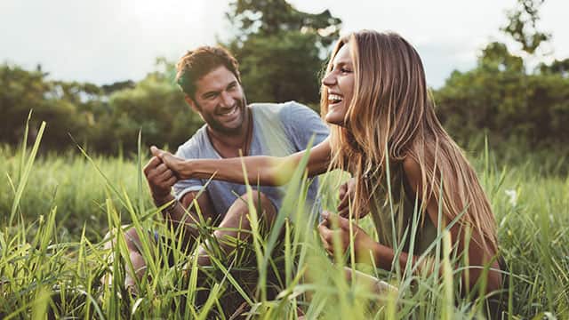 A couple in a green field