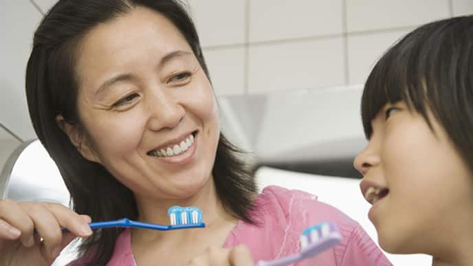 mom and son brushing their teeth