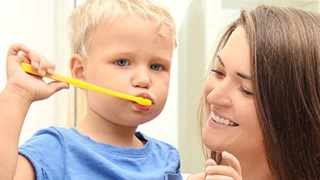 Mother teaching her child how clean