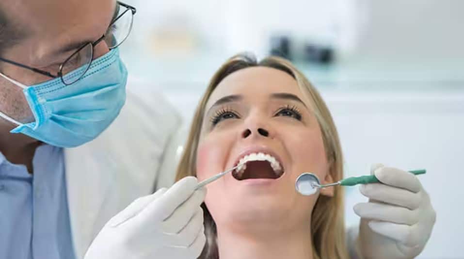 Lady getting a dental checkup for plaque on teeth