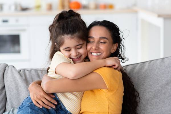 Mama abrazando a hija sonriente