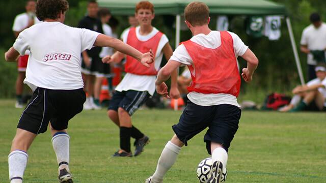 Teenagers playing soccer