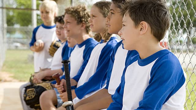 Side view little league baseball team waiting to bat