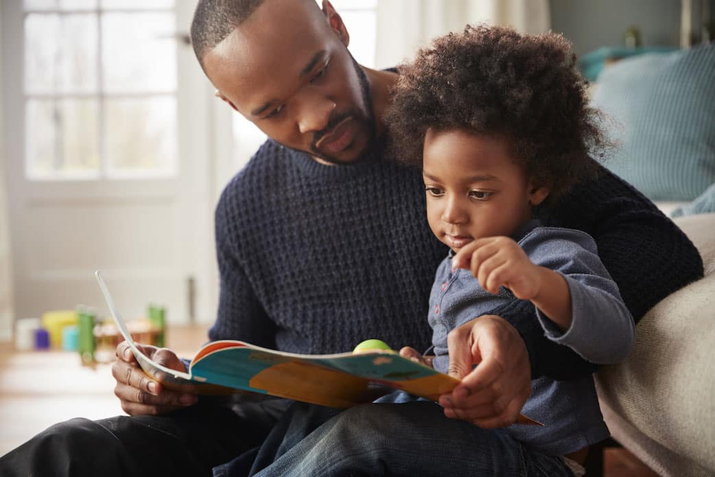 father reading book with his daughter