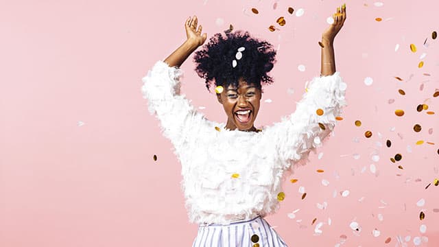 smiling woman throwing confetti