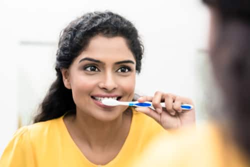 woman brushing her teeth