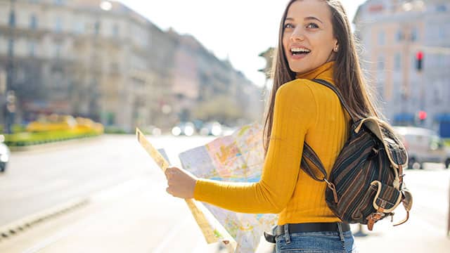 Woman checking a city map while out in the city 