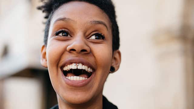 Young woman with piercing laughing