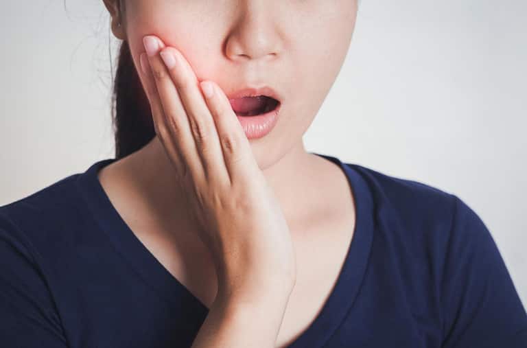 woman-touching-cheek-lip-pain