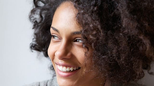 A woman smiling indoors