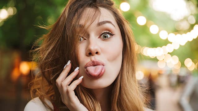 happy women sticking her tongue out to the camera 