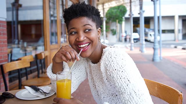 woman drinking orange juice