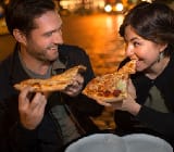 Couple eating pizza