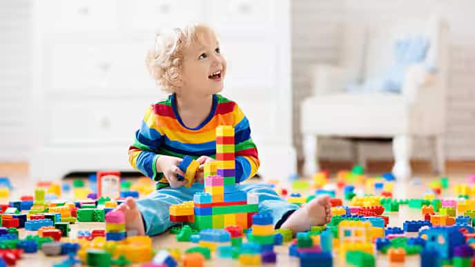 Young child playing with legos