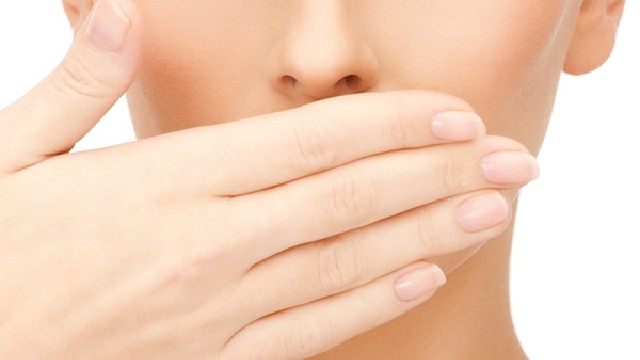 a young women is tesing if she has bad breath on her own