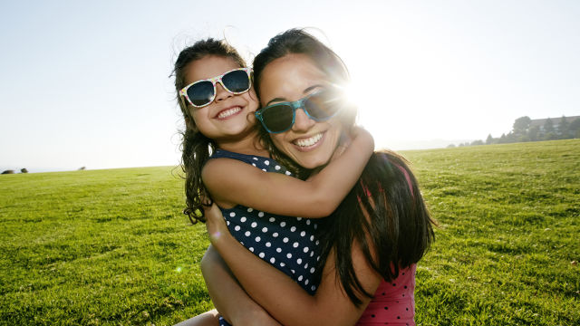 Mother and daughter smiling at the camera