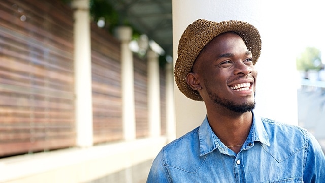 a young man is smiling after treating yellow teeth	