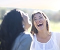 three women laughing outdoor