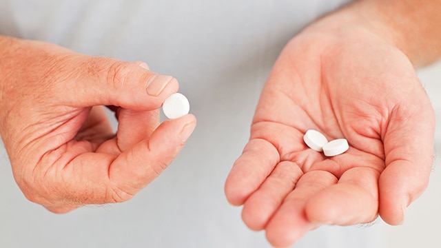 Persona contando pastillas de antibióticos