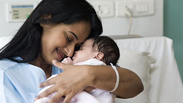 A mother holding her baby after birth