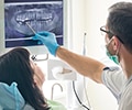 dentist showing a dental x-ray chart to a patient