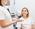 Young woman talking to dentist