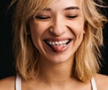 A young woman wearing braces and smiling