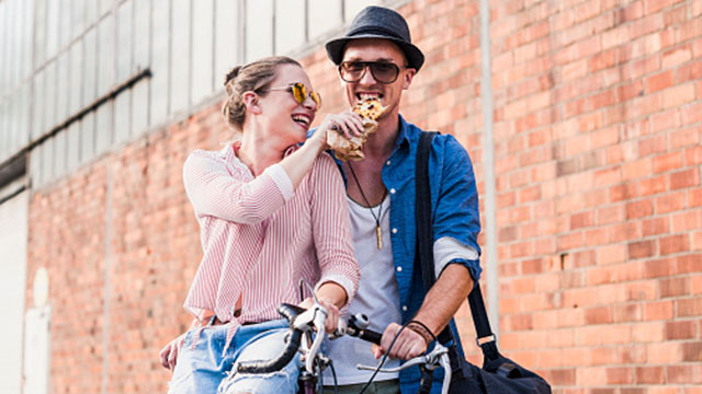 A couple sharing a snack outdoors