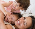 Mother and two daughters in bed