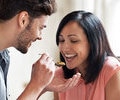 Young couple tasting vegetable stew