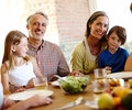 Grandparents with children and grandchildren at the dinner table