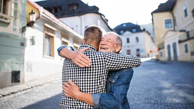 Father hugging his son outdoors