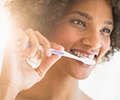 Portrait of woman brushing teeth