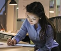 Businesswoman with digital tablet working late in an office