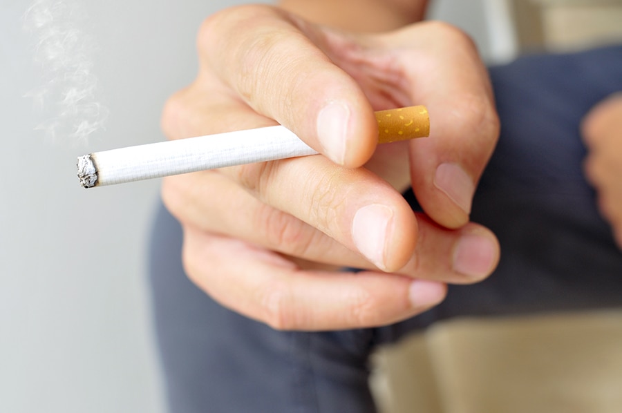 Hombre joven fumando un cigarro