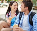 A young couple eating ice cream outdoors