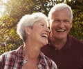 Middle age couple smiling outside