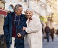 Senior couple walking on the city street on a winter day