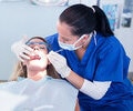 A dentist at work with the patient