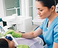 Healthcare professional administering laughing gas.