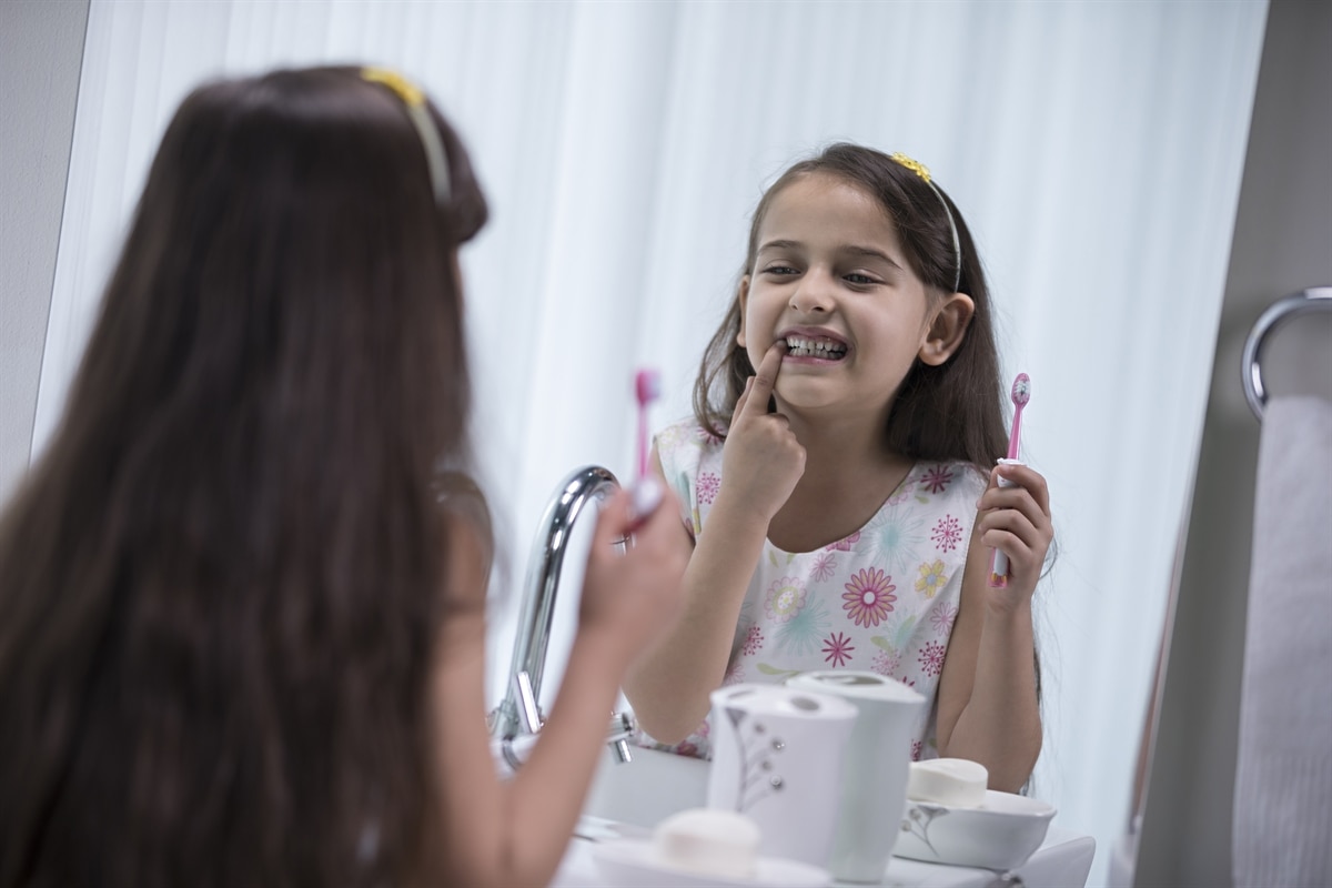 Girl brushing her teeth