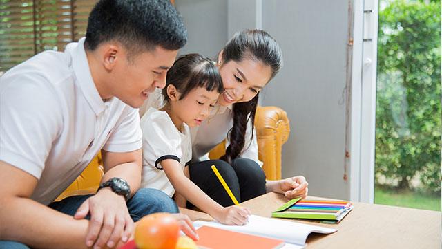 Parents teaching their daughter about food pyramid