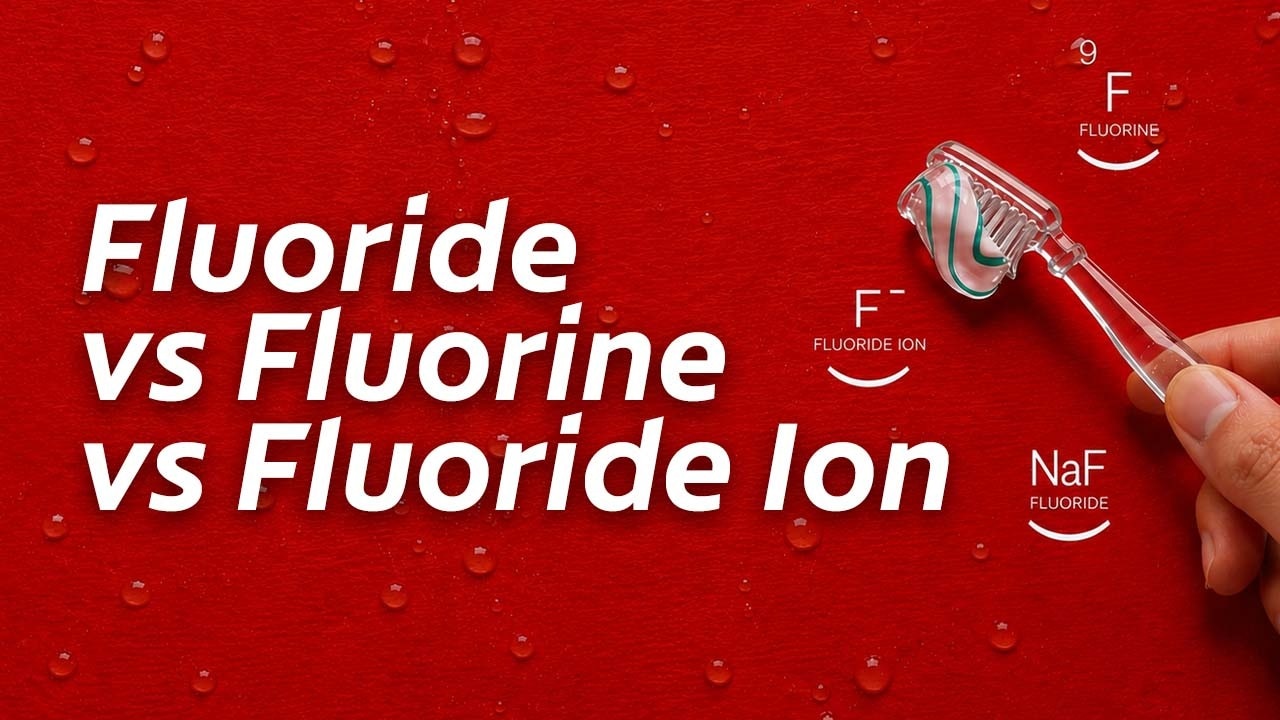 A toothbrush with toothpaste on a red surface with water droplets, alongside chemical symbols for Fluorine (F), Fluoride Ion (F⁻), and Fluoride (NaF). Overlay text reads: Fluoride vs Fluorine vs Fluoride Ion.