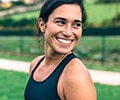 A woman is smiling outside