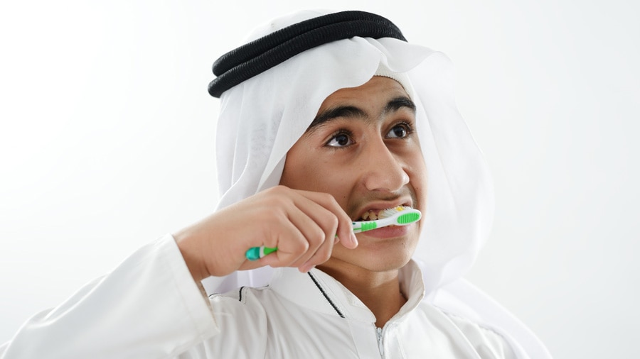 Arabic kid brushing teeth