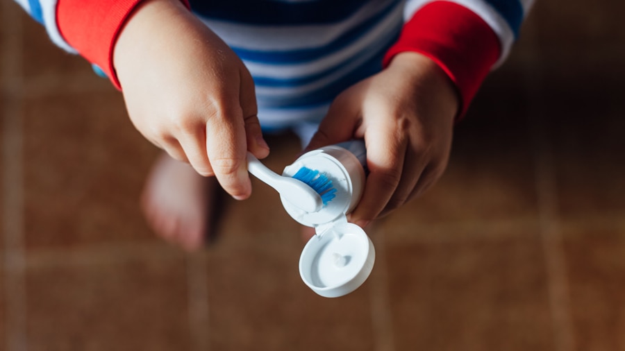 A kid trying best toothpaste for kids with cavities - Colgate