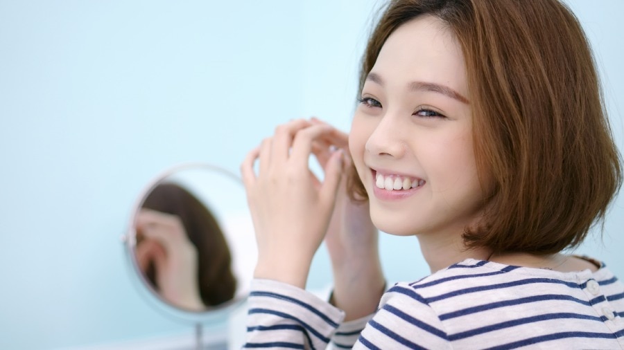 Woman smiling and showing teeth without black spots after dental care