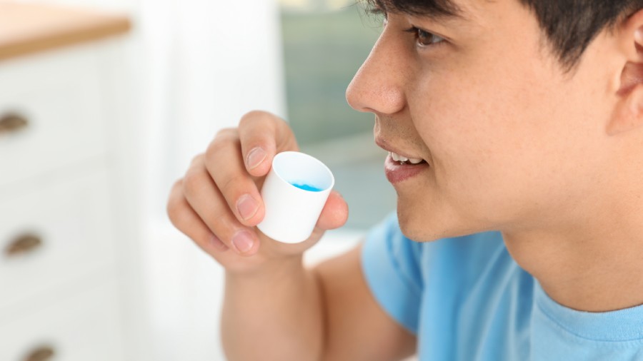 Young man holding medicines for tonsil stones treatment